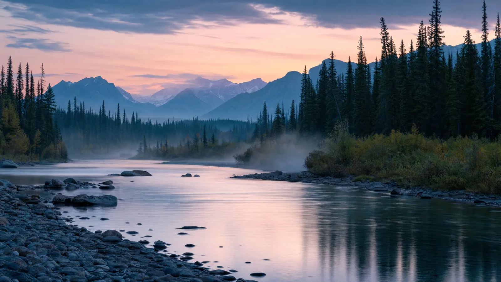 Calm river and mountain forest landscape in soft evening light